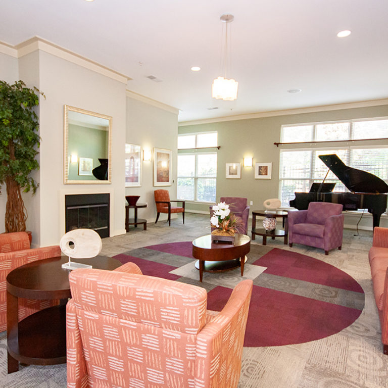 Great room with piano at Columbia Blackshear Senior Residences - Senior Apartments in Atlanta, GA