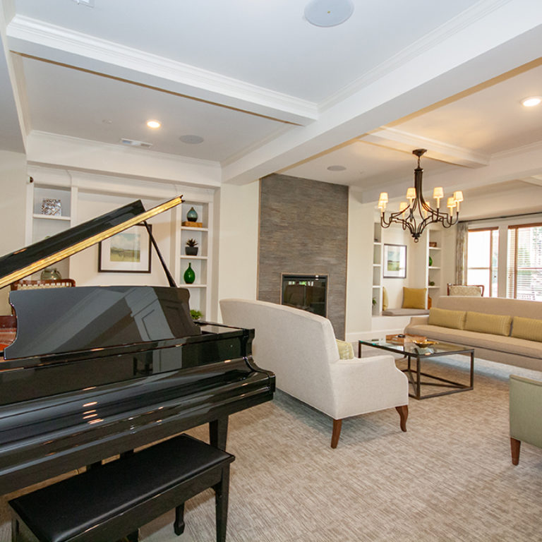 Great room with piano at Columbia Senior Residences at Forrest Hills - Senior Apartments at Decatur, GA