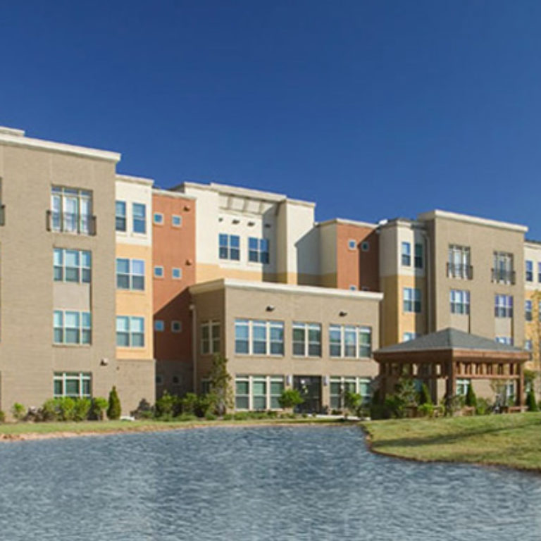 Exterior view of Columbia Senior Residences at MLK Village with lake - Senior Apartments in Atlanta, GA