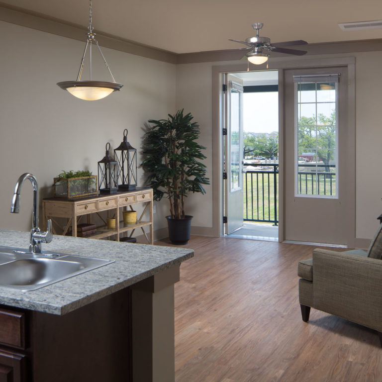 Residence living room at Heritage Senior Residences at Columbia Parc - New Orleans, LA