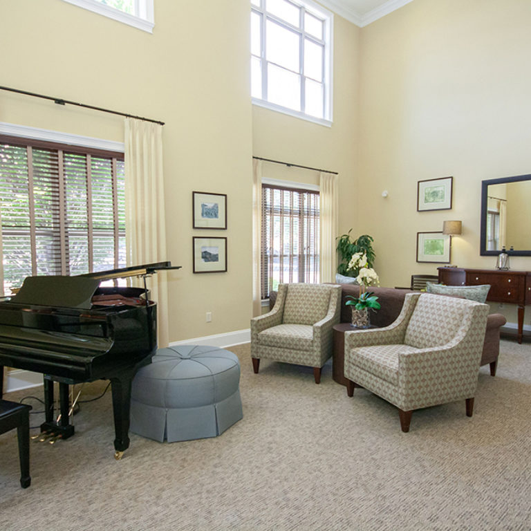 Great room with piano at The Retreat at Dorsey Manor - Senior Apartments in Marietta, GA