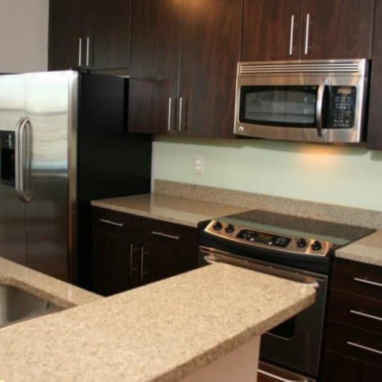 Kitchen with Granite Countertops and stainless steel appliances at Artist Square Atlanta Georgia