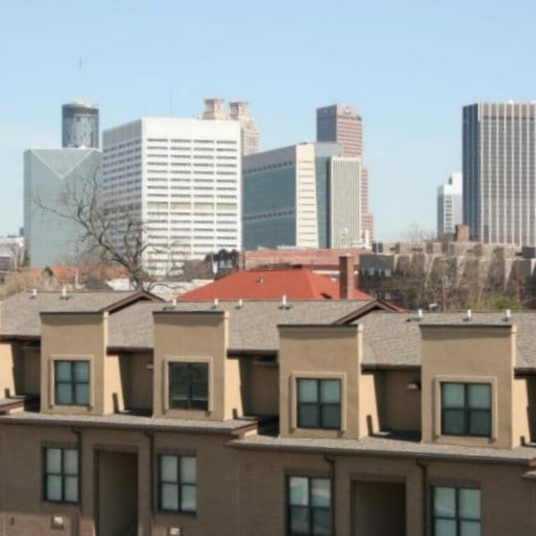 Photo of city skyline behind Artist Square apartments in Atlanta Georgia