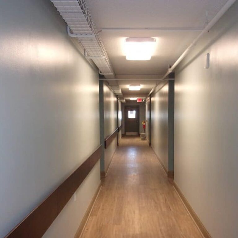 photo of long lighted hallway inside senior apartment