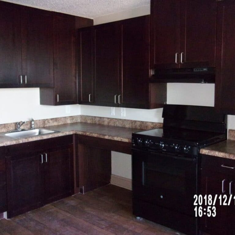 view of kitchen with dark wood finishes and granite counters
