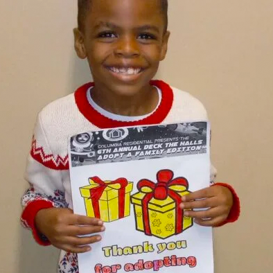 Young, Smiling, African American Boy, with Adopt a Family registration card