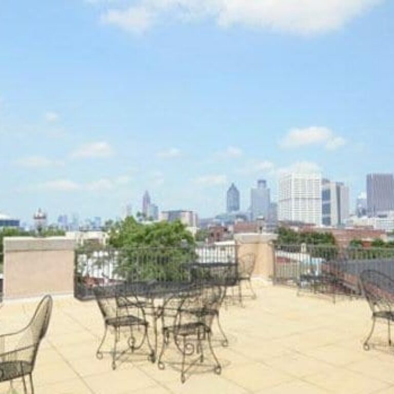 patio with bistro seating overlooking atlanta skyline