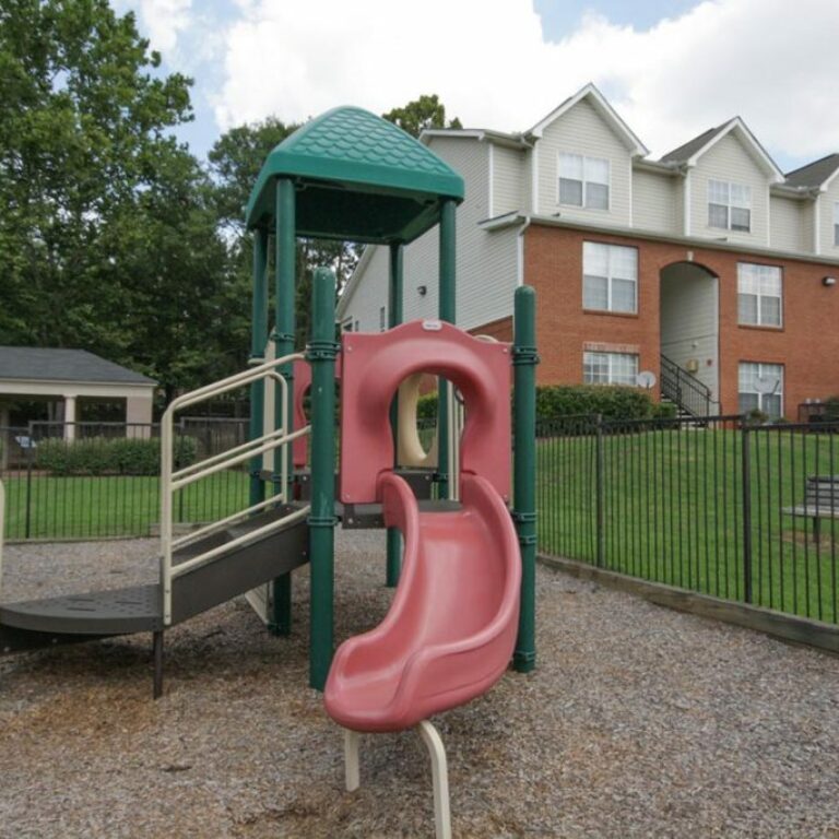childrens playground with apartments in background at villages of castleberry hill