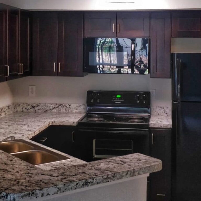 kitchen with dark wood finishes and granite countertops