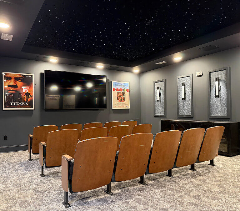 On-site theater room with seating at Miles Crossing Senior Residences