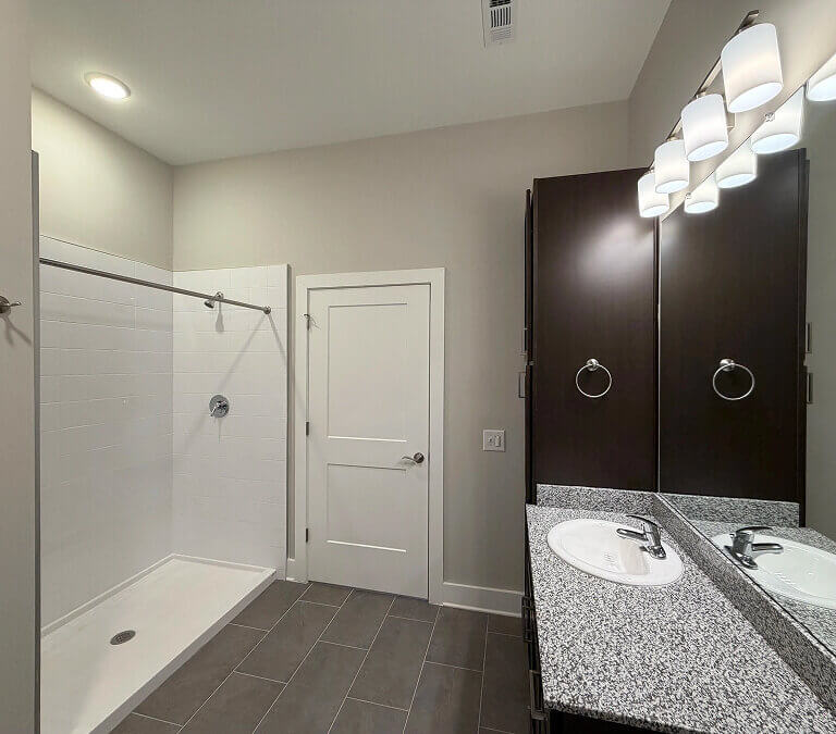Modern apartment bathroom with walk-in shower and vanity